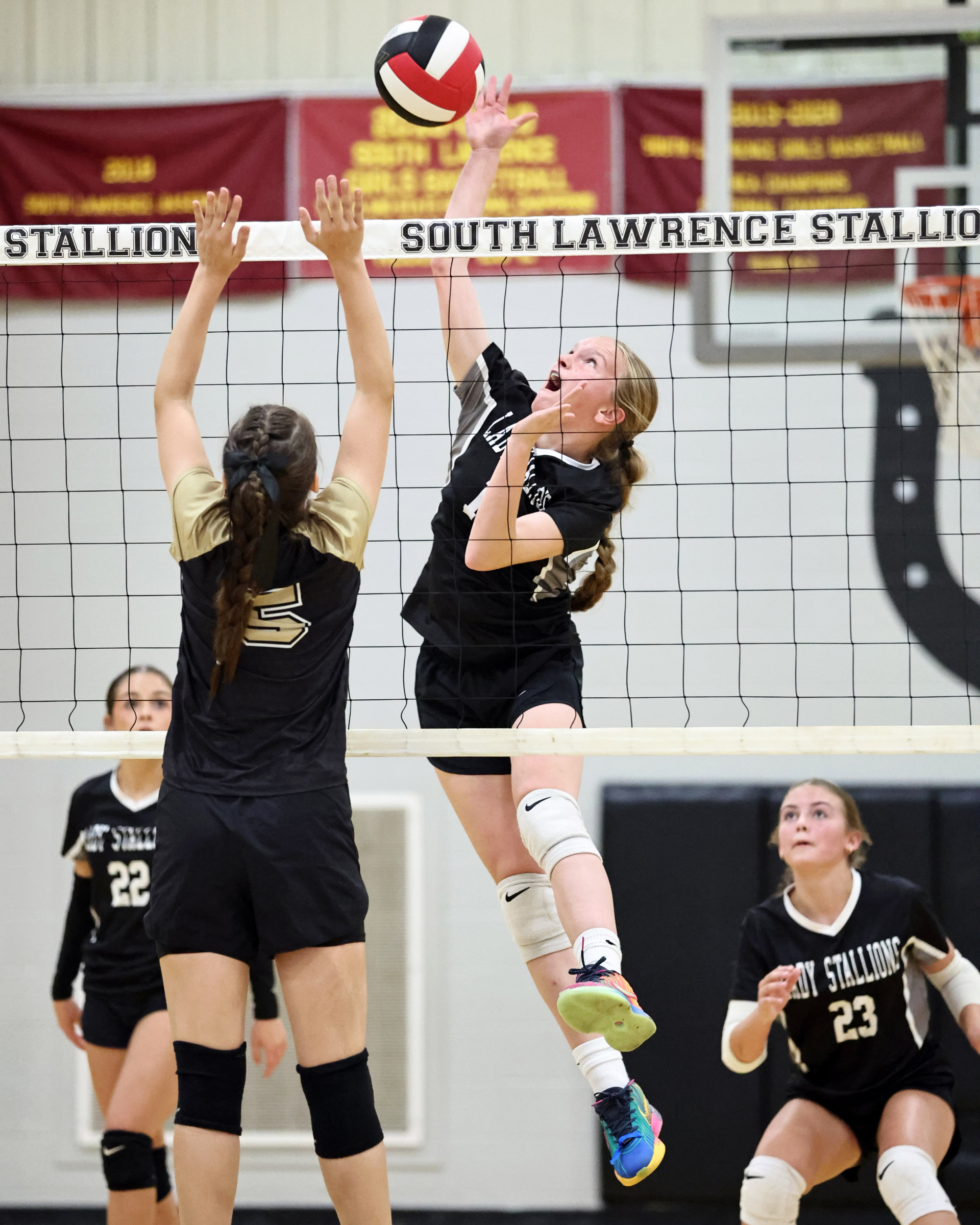 A South Lawrence player spikes the ball.