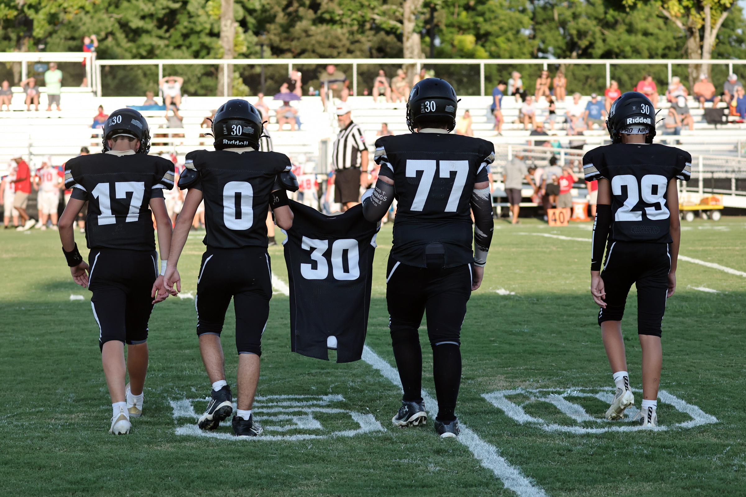 Mustang Captains gather at midfield prior to the game.