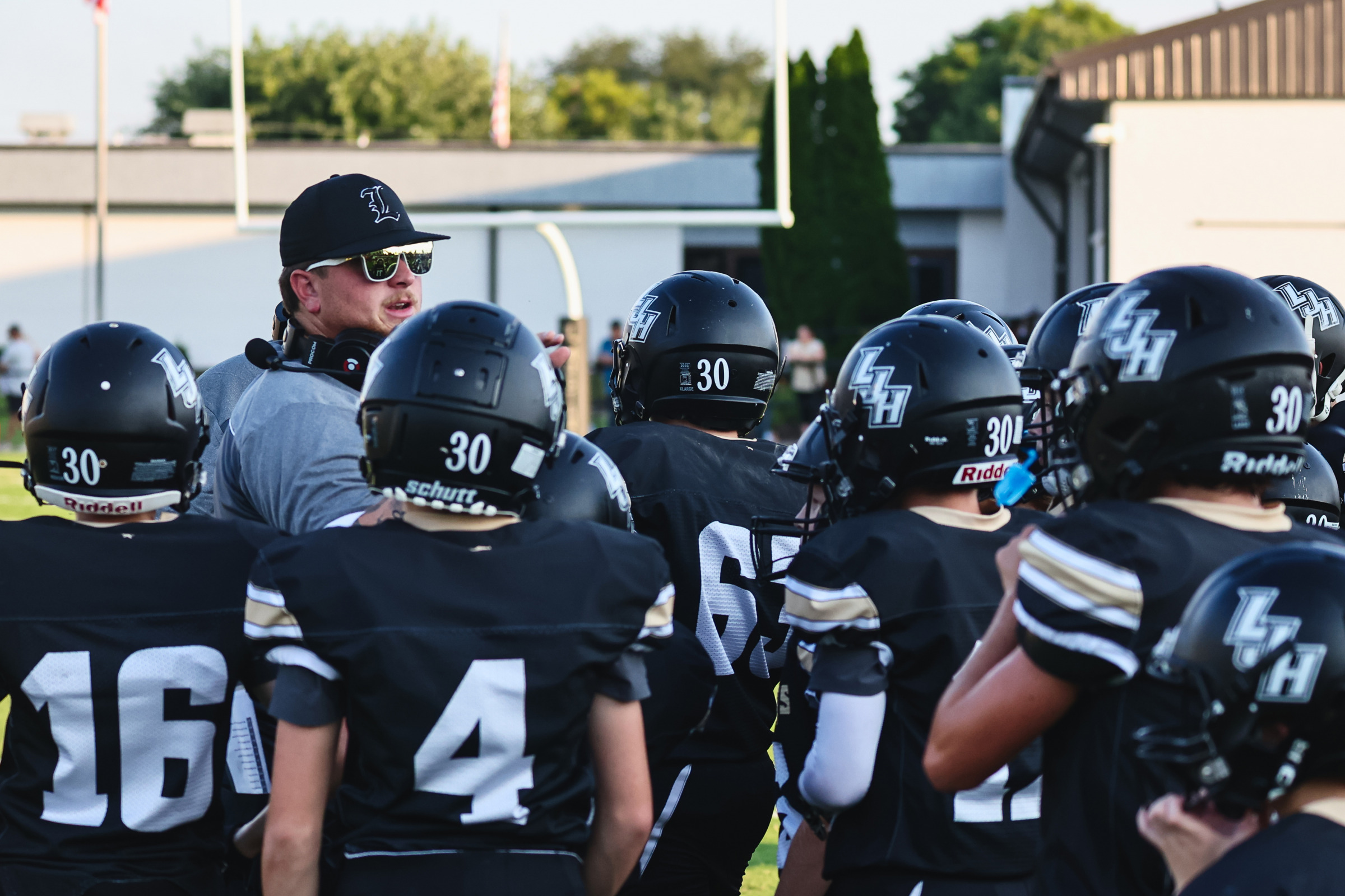 Head Coach Daniel Smith talks with his team