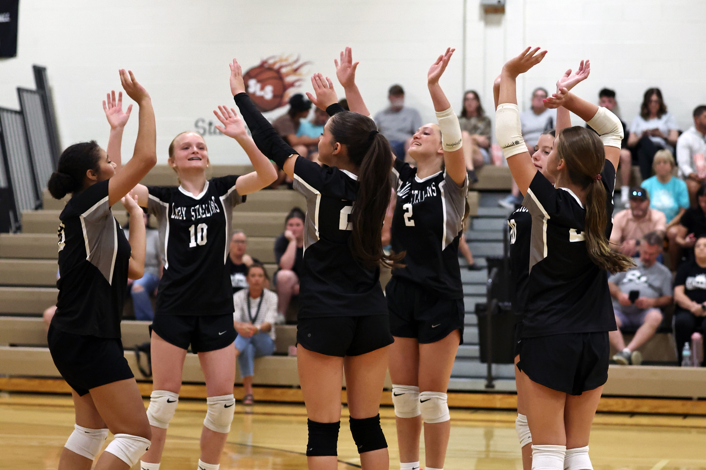 South Lawrence celebrates a point during Monday's win over New Prospect