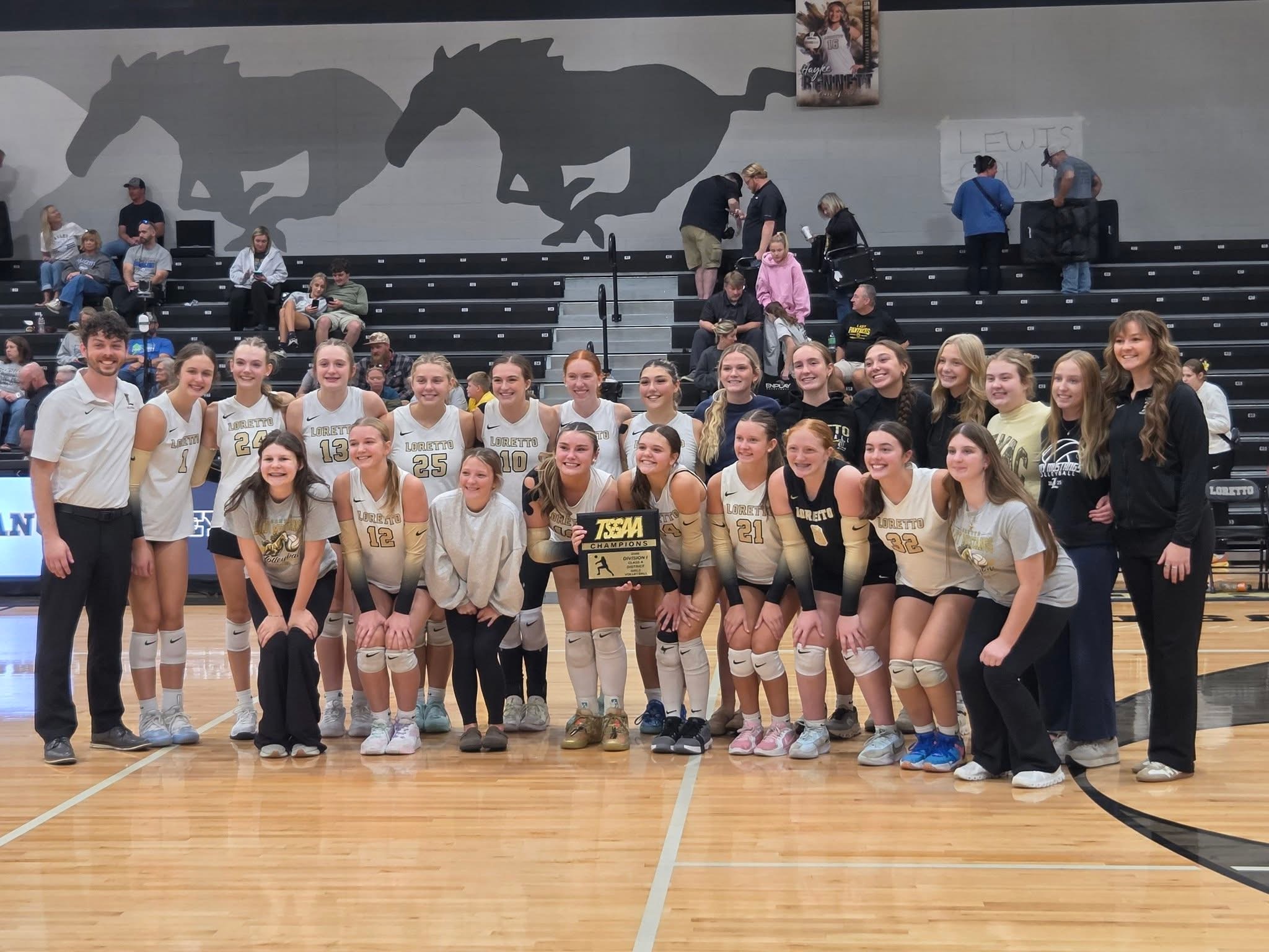The Loretto Lady Mustangs Volleyball team poses with their District Championship trophy.