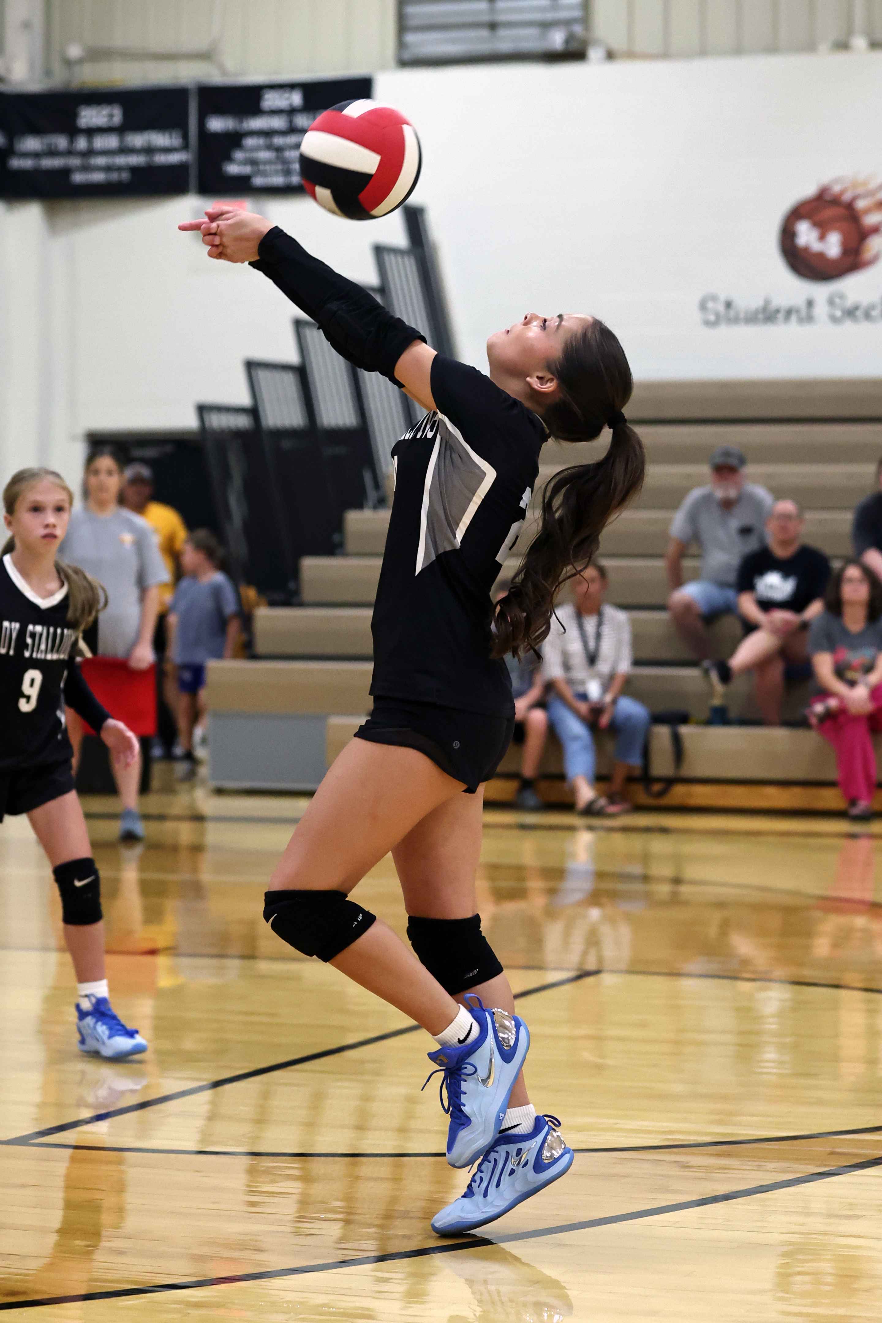 Izzy Tate Garland passes to a teammate during volleyball action.