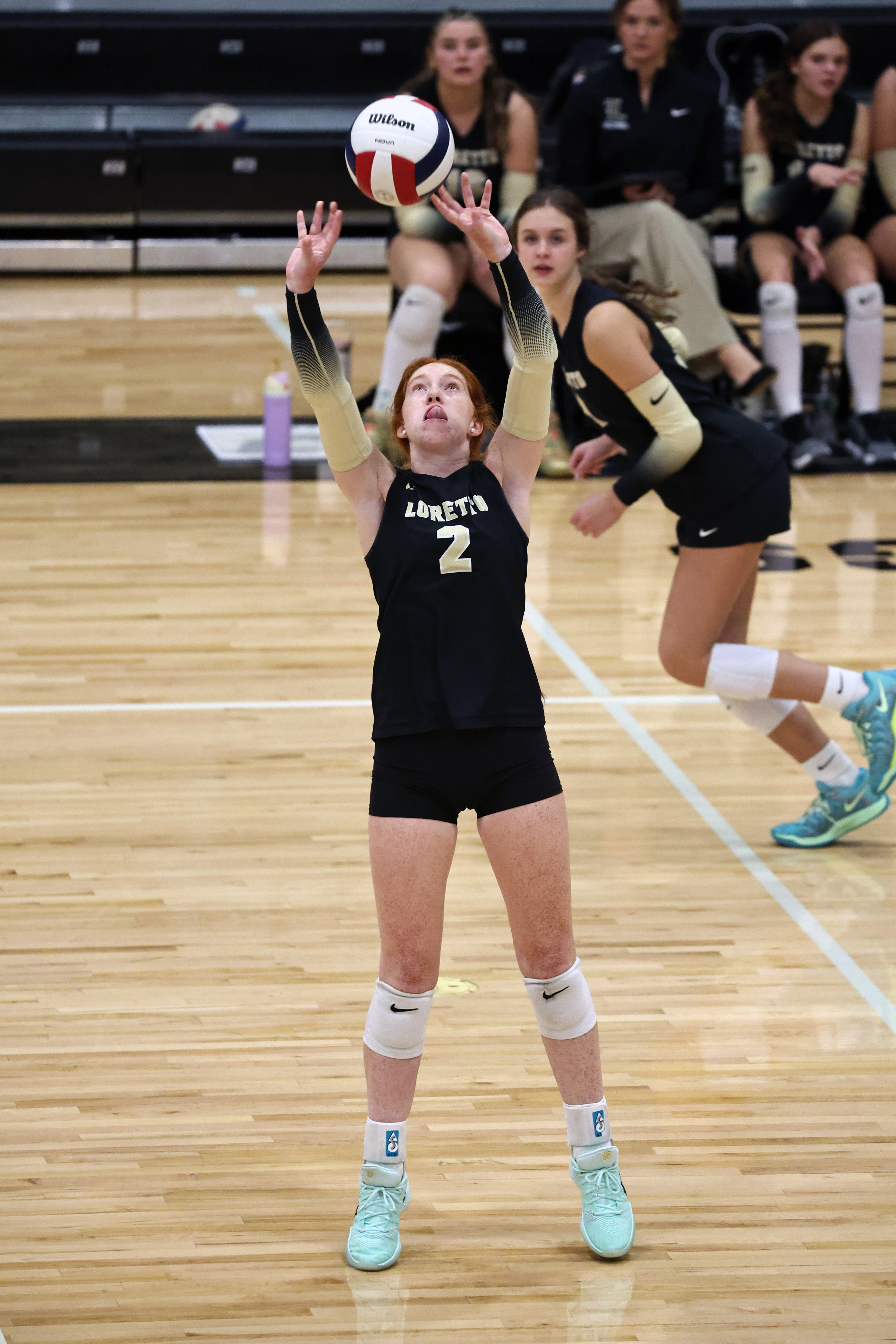 Tate Newton sets the ball to a teammate during game action.